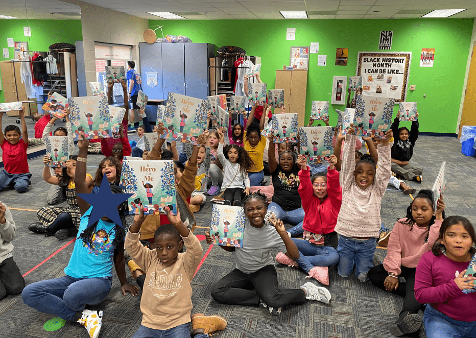 books in their hands, children holding the book "a hero like me"